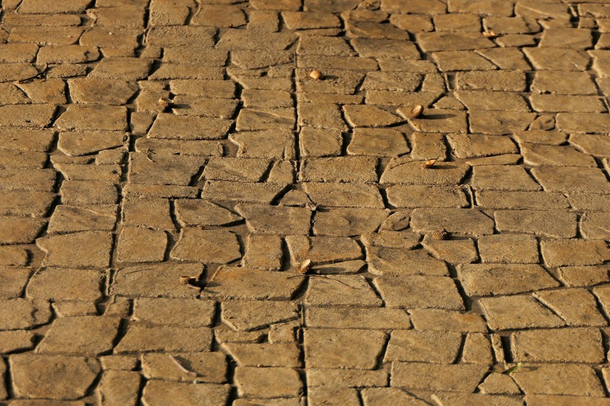 Brown stamped concrete with a cobble pattern